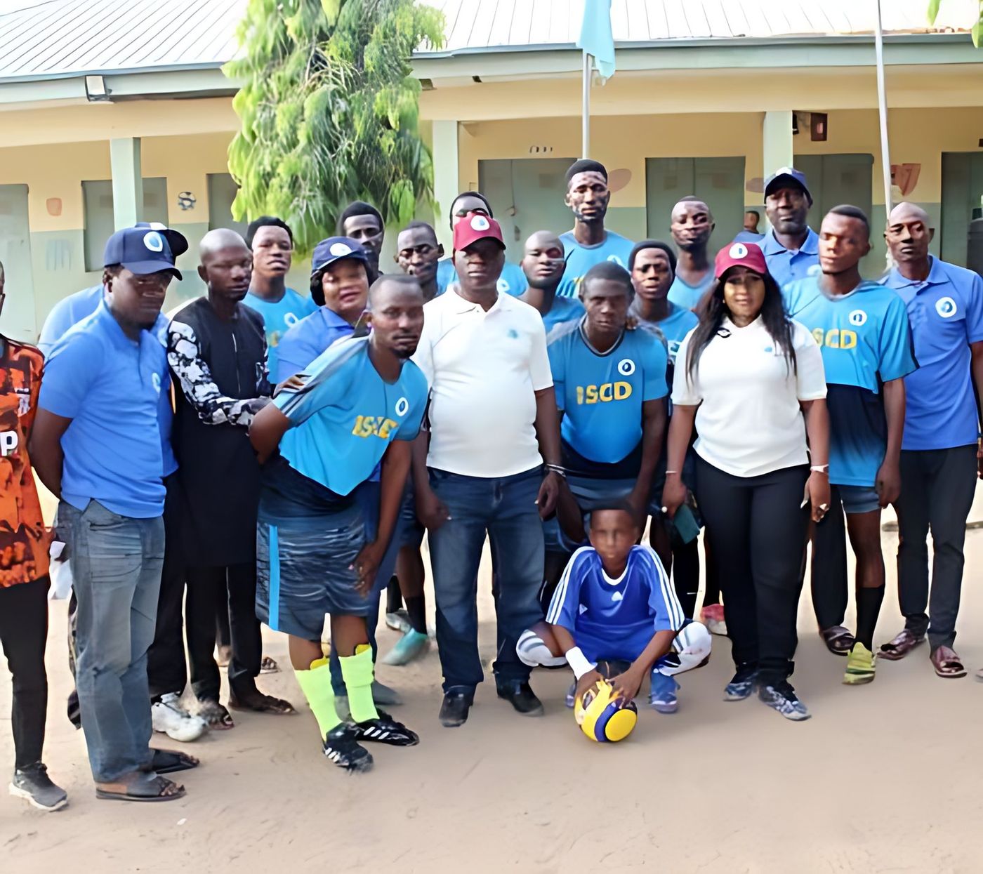 ISCD volunteers and pupils at a school field